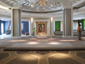 In this Aug. 8, 2016 photo, workers are seen in the circular lobby area of the new 450-room Guest House at Graceland in Memphis, Tenn.  (AP Photo/Adrian Sainz)