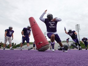 Members of the Western Mustangs defensive line deke their way around obstacles during the first day of football training camp at TD Stadium on Monday. (CRAIG GLOVER, The London Free Press)