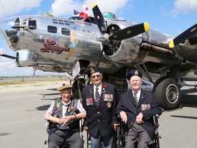 Second World War veterans Laurent Constantineau, left, Wilbert Spencer and Lorne Anderson pose near a B-17 bomber at the Greater Sudbury Airport in Greater Sudbury, Ont. on Monday August 15, 2016. John Lappa/Sudbury Star/Postmedia Network