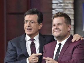 In this Oct. 9, 2015 photo released by CBS, Stephen Colbert, host of "The Late Show with Stephen Colbert", left, appears with James Corden, host of "The Late Late Show with James Corden," during a taping of Colbert's show in New York. (John Paul Filo/CBS via AP)
