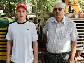 Cambell (left) and Gordon Mackay stand amidst their tractor collection. The father-son pair of Blue Ridge have amassed over 70 tractors from across the continent.