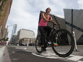 A cyclist uses the Bloor St. bike lanes on August 15, 2016. (STAN BEHAL/Toronto Sun)