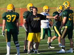 Golden Bears running backs coach Terry Eisler sets up a drill during camp at Foote Field on Monday. (David Bloom)