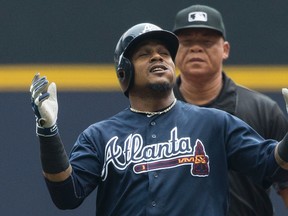 Atlanta Braves’ Erick Aybar reacts to hitting a double Thursday, Aug. 11, 2016, in Milwaukee. (AP Photo/Tom Lynn)