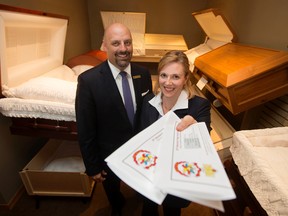 South Side Memorial Chapel funeral directors Eden Tourangeau and Kristie Tourangeau pose for a photo with Edmonton Fringe tickets in Edmonton on Tuesday Aug. 16, 2016. South Side Memorial Chapel is holding an open house and funeral home tours during the Edmonton Fringe. The funeral home was giving away fringe tickets to some of their open house visitors.