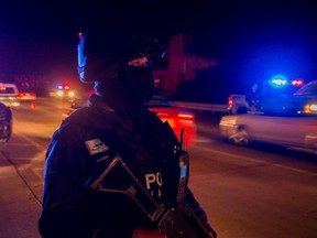 Mexican police stand guard on a street during a security operation in Bahia de Banderas, Nayarit State, Mexico, on Aug. 16, 2016. 
Jesus Alfredo Guzman Salazar, son of drug lord Joaquin "El Chapo" Guzman, was among a group kidnapped from a bar in the Mexican resort city of Puerto Vallarta, authorities confirmed. (HECTOR GUERRERO/AFP/Getty Images)
