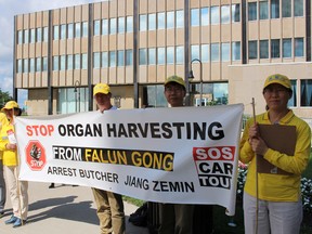 Members of the Falun Dafa Association of Toronto spoke with members of the public outside of Sarnia city hall Wednesday morning. They're currently on a road trip to spread public awareness about the persecution of Falun Dafa practitioners in China. Pictured here, from left to right, are practitioners Cain Zheng, Li Liu, Peter Cao, Steven Liu and Na Gan. (Barbara Simpson/Sarnia Observer)