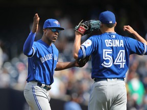Toronto Blue Jays' Melvin Upton Jr., left, celebrates with relief pitcher Roberto Osuna after a game against the New York Yankees at Yankee Stadium on Aug. 17, 2016. (AP Photo/Seth Wenig)