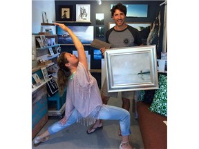 The Trudeaus pose with a painting they purchased while visiting Tofino, B.C. (CHRISTOPHER POUGET Photo)