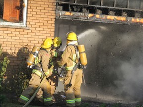 Firefighters battle a house fire at 11 Anita Blvd., in Sault Ste. Marie, Ont., on Thursday, Aug. 18, 2016. (BRIAN KELLY/THE SAULT STAR/POSTMEDIA NETWORK)