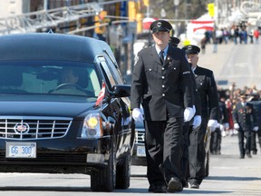 Thousands paid their respects during a funeral procession in March 2011 in honour of North Perth Fire Department members Ken Rea and Ray Walter, who died in a blaze at the Dollar Stop store in the Listowel downtown. (SCOTT WISHART/The Beacon Herald files)