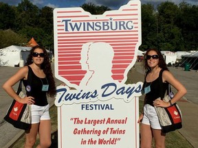Sarnia's Adrianna Arcuri, left, and Carmella Arcuri stand next to the welcome sign at this year's Twins Day Festival in Twinsburg, Ohio. More than 1,800 sets of twins and other multiples attended the three-day event. (Handout)
