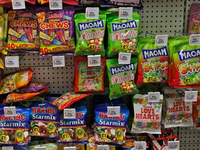 Sweets are on display at a shelf in a supermarket in London, Thursday, Aug. 18, 2016. Britain has unveiled a plan to battle rising child obesity by urging food manufacturers to cut down on sugar and getting primary schools to make pupils do more exercise. But health campaigners have slammed the government for failing to restrict junk food advertising aimed at children.(AP Photo/Frank Augstein)