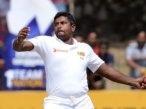 Sri Lanka's Rangana Herath delivers a ball during the final day of the third and final Test match between Sri Lanka and Australia at The Sinhalese Sports Club (SSC) Ground in Colombo on August 17, 2016. (AFP PHOTO/LAKRUWAN WANNIARACHCH)