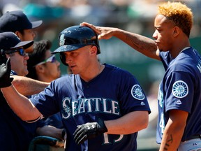 Kyle Seager of the Seattle Mariners is congratulated by Ketel Marte after hitting a three run double against the Oakland Athletics during the sixth inning at the Oakland Coliseum on August 14, 2016 in Oakland, California. (Jason O. Watson/Getty Images)