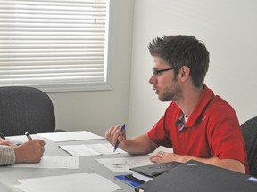 Murray Marton, left, who farms east of Arrrowood, opened accounts recently with the ATB, with the ATB’s Dustin Gass guiding him through the process, at the Arrowwood Business Centre. Stephen Tipper Vulcan Advocate