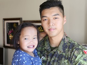 Kris Chung, 21, of Vancouver holds Binh Wagner, 5, at her home in Kingston, Ont. on Thursday, Aug. 18, 2016. Chung donated a portion of his liver to Binh last year for a transplant that saved her life. He is going into his third year at the Royal Military College of Canada . Elliot Ferguson/The Whig-Standard/Postmedia Network