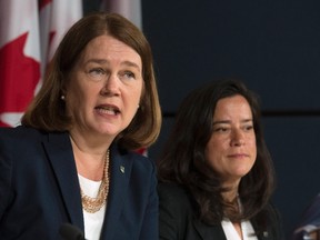 Minister of Health Jane Philpott responds to a question as Minister of Justice and Attorney General of Canada Jody Wilson-Raybould looks on during a news conference in Ottawa, Thursday June 30, 2016. THE CANADIAN PRESS/Adrian Wyld