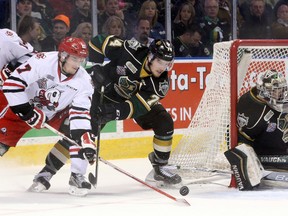 Niagara IceDogs defenceman William Lochead loses control of the puck while being pressured by London Knights defenceman Aiden Jamieson while Knights goaltender Tyler Parsons covers his net during game 2 of their OHL championship hockey series at Budweiser Gardens in London, Ont. on Saturday May 7, 2016. The Knights won the game 6-1, taking a 2-0 lead in the series.  Craig Glover/The London Free Press/Postmedia Network