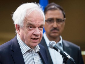 John McCallum, Minister of Immigration, Refugees and Citizenship speaks to the media following a roundtable discussion with local organizations on Thursday, August 18, 2016 in Edmonton while Amarjeet Sohi, Minister of Infrastructure and Communities listens.  Greg Southam / Postmedia