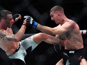 Colby Covington, left, lands a kick on Jonathan Meunier during their welterweight bout at UFC Fight Night 89 in Ottawa on Saturday, June 18, 2016. (THE CANADIAN PRESS/Fred Chartrand)