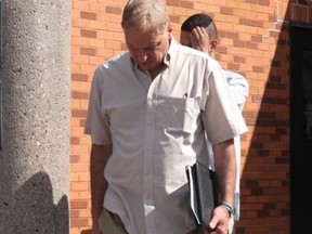 Maurizio Morello blocks his son Julian Morello from cameras as they leave court Thursday, Aug. 18, 2016 in Barrie. (Tracy McLaughlin/Toronto Sun)