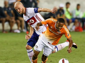 TFC's Michael Bradley fights for the ball with a Houston Dynamo player during their game on Sunday. (AP)