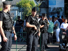 French police officers patrol near the site of the sanctuary in Lourdes, southwestern France, in this Aug. 15, 2016 file photo. (AP Photo/Bob Edme)