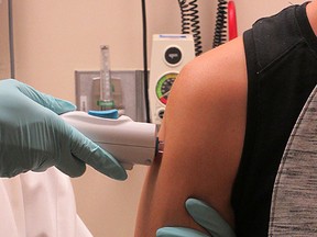 In this photo provided ​by The National Institute of Allergy and Infectious Diseases shows a healthy volunteer receiving the NIAID Zika virus investigational DNA vaccine as part of an early-stage trial to test the vaccine's safety and immunogenicity. This is the first administration of this vaccine in a human. (​The National Institute of Allergy and Infectious Diseases via AP)