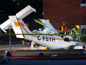 Emergency crews and TSB workers work at the scene of a plane crash near High and Lansdowne streets in Peterborough, Ont., on Aug. 12, 2016. (Clifford Skarstedt/Peterborough Examiner/Postmedia Network)