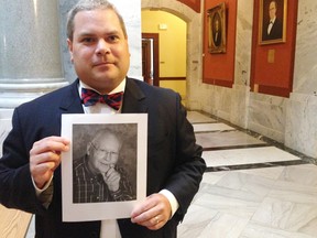 Attorney Steven Megerle holds a photo of his client, Elmer Riehle, outside of the Kentucky Supreme Court on Friday, Aug. 19, 2016, in Lexington, Ky. A jury declared Riehle mentally incompetent in 2008 and appointed his wife as his legal guardian. Now, Riehle wants a divorce. But Kentucky law won't allow it. The state Supreme Court will decide. (AP Photo/Adam Beam)