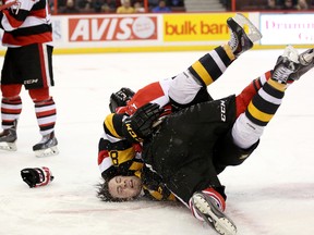 Troy Henley #3 of the Ottawa 67's slams Mack Lemmon #80 of the Kingston Frontenacs onto the ice during a fight during an OHL game at Canadian Tire Centre on March 11, 2014 in Ottawa.  (Jana Chytilova/Freestyle Photography/Getty Images)