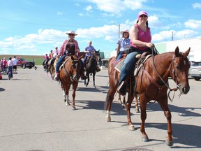 Horseback riders ride through Arrowwood for Wild Pink Yonder. See next week's newspaper for full story.