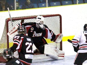 Lambton Shores Predators goalie Anthony Hurtubise makes a save on Sarnia Legionnaires defenceman Brad Yowart at the side of the net during the Greater Ontario Junior Hockey League game at Sarnia Arena on Thursday Dec. 3, 2015 in Sarnia, Ont. Training camps begin this weekend for the Legionnaires, Predators and Petrolia Flyers. Terry Bridge/Sarnia Observer/Postmedia Network