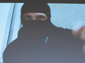 Aaron Driver switches off his video camera in a screen capture of a recording shown during an RCMP press conference for the terrorism incident in Strathroy where Driver was killed on Aug. 11. (Justin Tang/The Canadian Press)