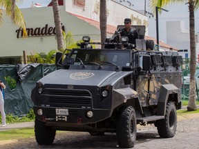 A state police officer patrols a street during a security operation in Puerto Vallarta in the western Mexican state of Jalisco on August 18, 2016. 
(AFP PHOTO / HECTOR GUERREROHECTOR GUERRERO/AFP/Getty Images)