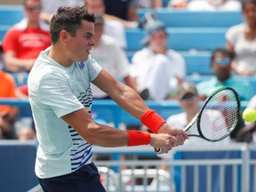 Milos Raonic, of Canada, returns to Dominic Thiem, of Austria, during the quarterfinals of the Western & Southern Open tennis tournament, Friday, Aug. 19, 2016, in Mason, Ohio. (AP Photo/John Minchillo)