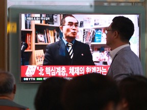 In this Wednesday, Aug. 17, 2016 file photo, people watch a TV news program showing a file image of Thae Yong Ho, a minister at the North Korean Embassy in London, at Seoul Railway Station in Seoul, South Korea.  (AP Photo/Ahn Young-joon. File)