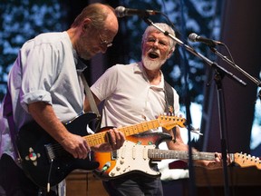 Paul Barrere, left, and Fred Tackett perform during the opening night of the Edmonton Blues Festival in Hawrelak Park, in Edmonton on Friday Aug. 19, 2016. Photo by David Bloom / Postmedia