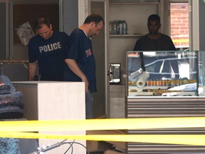 Police and fire officials investigate an Aug 19 explosion at Tweeder medical marijuana dispensary on Eglinton Ave. W. near Avenue Rd. in Toronto Saturday August 20, 2016. (Michael Peake/Postmedia Network)