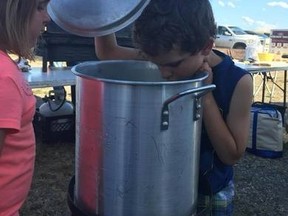 Blayke Coldwell and Brooke Nehring, both 6, disappointedly look into empty pots that were supposed to have fresh lobster cooking on Aug. 13.