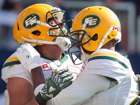 Edmonton Eskimos wide receiver Nate Coehoorn, left, celebrates scoring a touchdown with slotback Adarius Bowman during first half CFL football action in Toronto on Saturday, August 20, 2016.