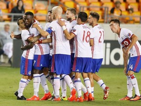 Toronto FC forward Jozy Altidore celebrates with teammates after scoring during the first half against the Houston Dynamo in an MLS soccer match in Houston on Aug. 14, 2016. (THE CANADIAN PRESS/AP, Bob Levey)