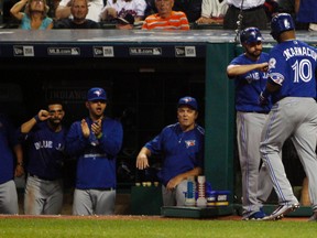 Edwin Encarnacion #10 of the Toronto Blue Jays is congratulated by teammates as he returns to the dugout after hitting a home run against  the Cleveland Indians during the fifth inning at Progressive Field on August 20, 2016 in Cleveland, Ohio. (Photo by David Maxwell/Getty Images)