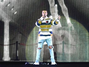 Justin Bieber, center, performs on the Virgin Media Stage during the V Festival at Hylands Park in Chelmsford, Britain, Saturday, Aug. 20, 2016. (Ian West/PA via AP)