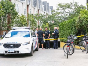 Toronto Police seal off the underground parking at 954 King St. W. at Crawford St. in Toronto after a man was found with gunshot wounds slumped over a motorcycle on Sunday August 21, 2016. (Dave Thomas/Toronto Sun)