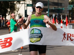 Brendan Lunty crosses the finish line first in the marathon during the 2016 Edmonton Marathon in Edmonton, Alta., on Sunday, Aug. 21, 2016.
