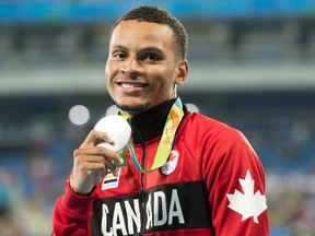 Canada's Andre De Grasse shows off his silver medal for the 200-metre at the Olympic games in Rio de Janeiro, Brazil, Friday August 19, 2016. THE CANADIAN PRESS/Frank Gunn