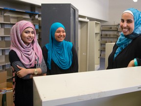 Maryium Mansur, 14, and Ayah Barghout, 14, and vice-principal Sally Kaloti check out the future site of the library at Al-Taqwa Academy?s new home in the former Sir Winston Churchill elementary school. (MIKE HENSEN, The London Free Press)