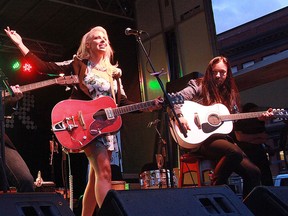 Bernard Clark photo
Prince Edward County native Emily Fennell Taylor performs with Tragically Hip bass guitarist Gord Sinclair, left, and lead guitarist Rob Baker in Kingston in this 2015 photo. “The Hip contribute culturally to both Kingston and Canada,” she says.